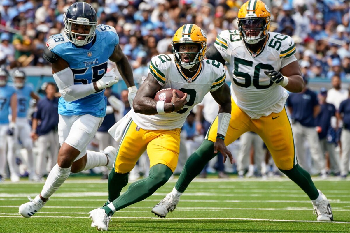 Green Bay Packers quarterback Malik Willis (2) runs the ball past Tennessee Titans linebacker Harold Landry III (58) during the second quarter at Nissan Stadium in Nashville, Tenn., Sunday, Sept. 22, 2024.