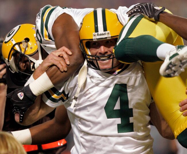 After breaking the NFL record for career touchdown passes, Green Bay Packers quarterback Brett Favre hoists its recipient, Greg Jennings, during the first quarter of their game against the Minnesota Vikings Sunday, September 30, 2007 at the Metrodome in Minneapolis, Minn. Favre's 421st touchdown pass eclipsed Dan Marino's record. © Mark Hoffman / Milwaukee Journal Sentinel / USA TODAY NETWORK via Imagn Images